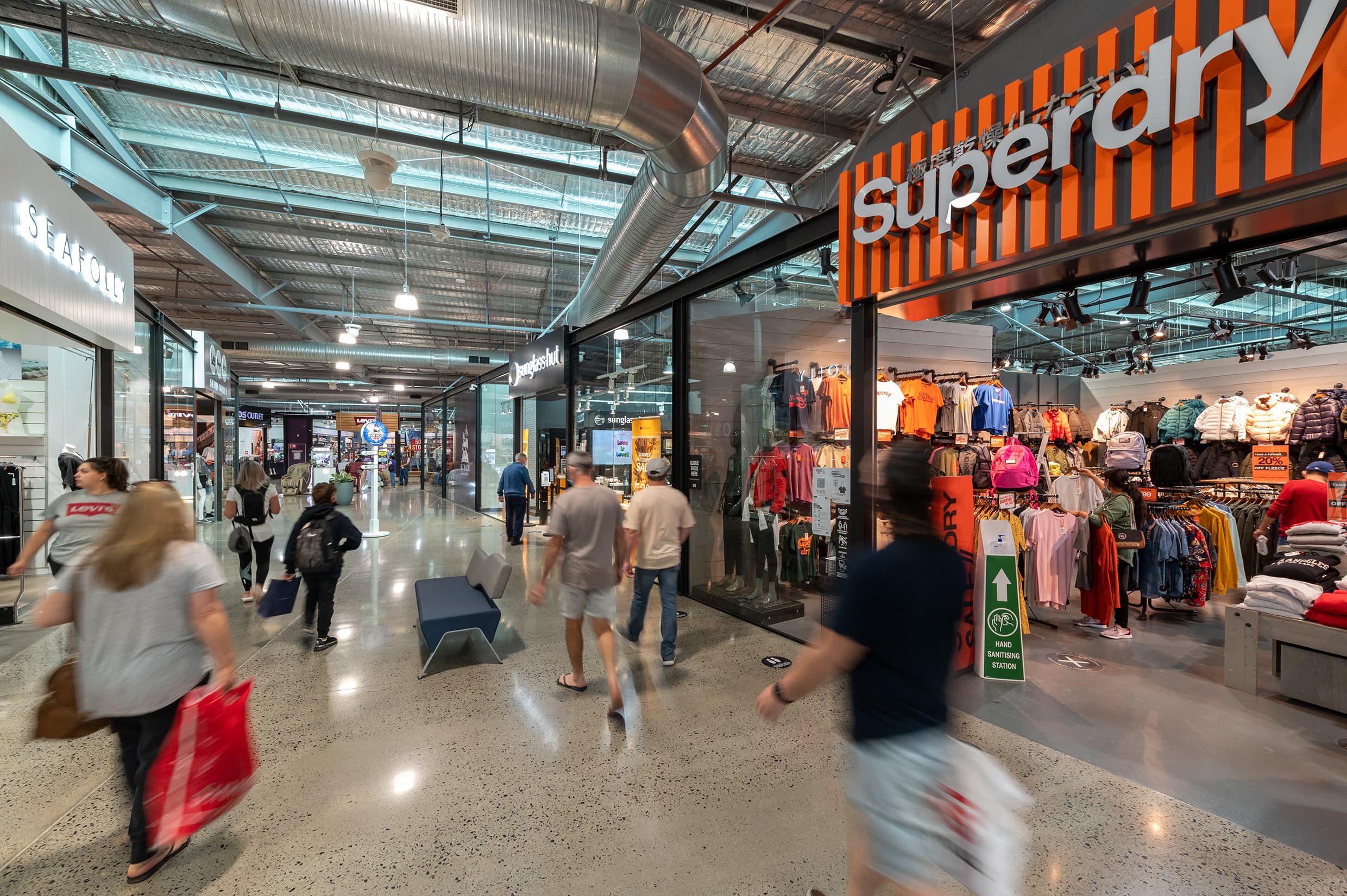 An industrial style shopping centre with a Superdry storefront