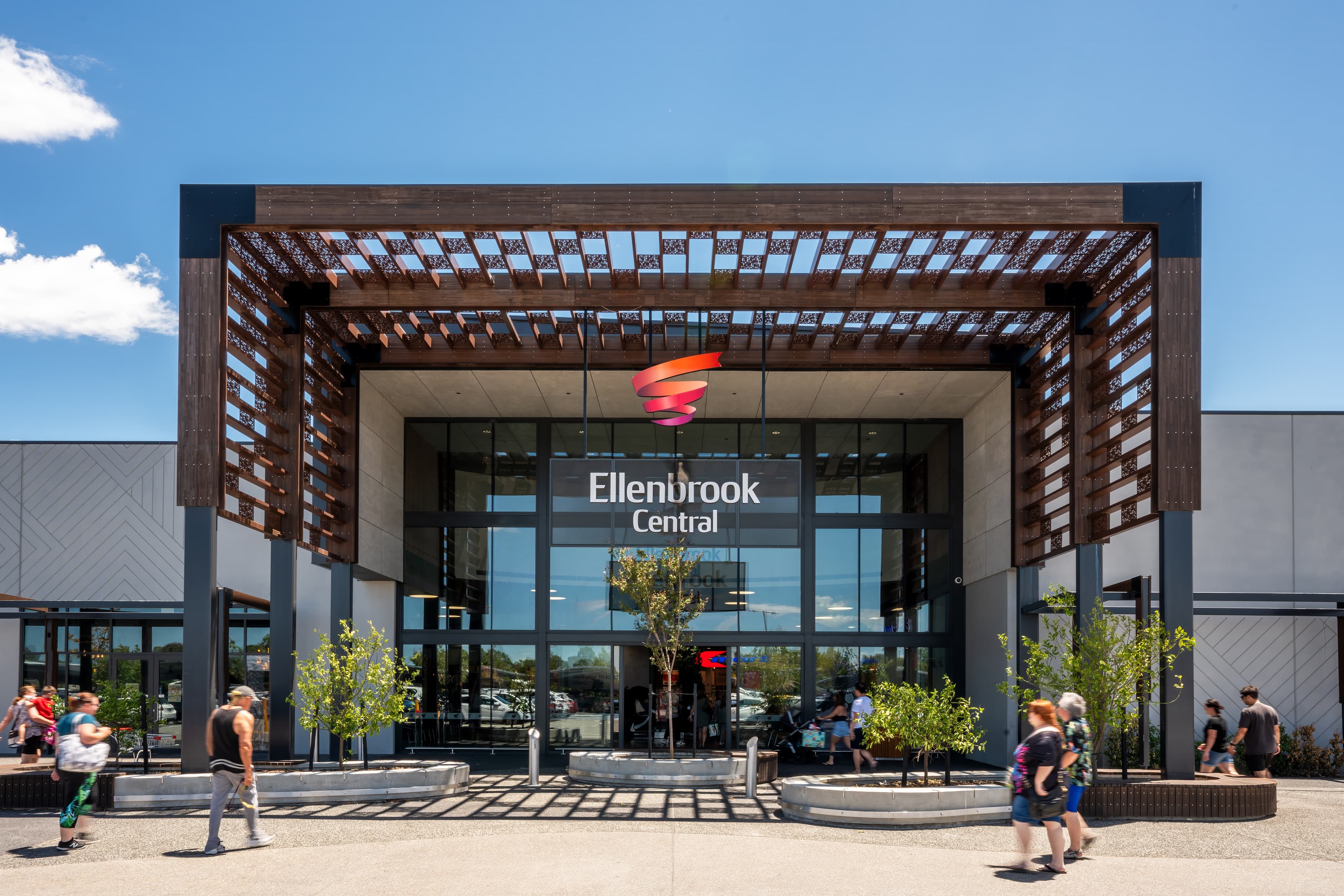 Shopping centre entrance with large brown canopy and glass frontage