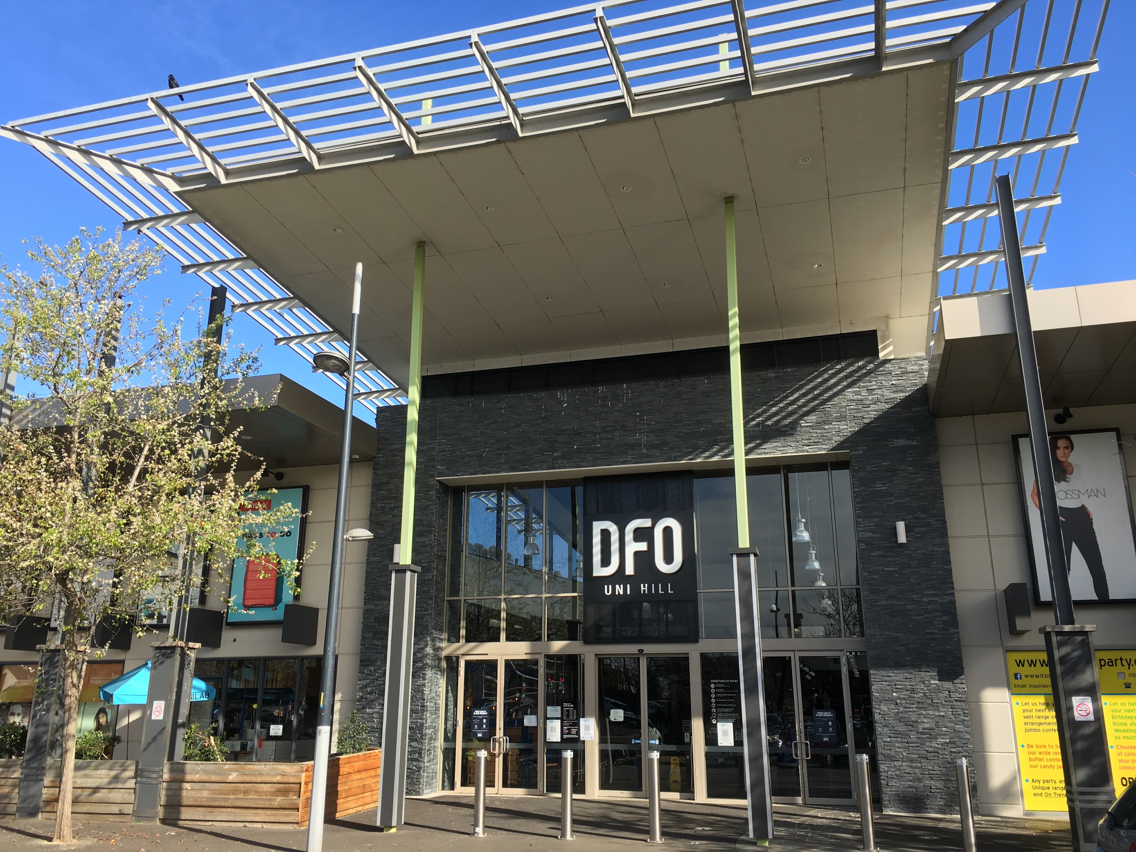 Shopping centre entrance with large canopy and DFO Uni Hill sign at the front